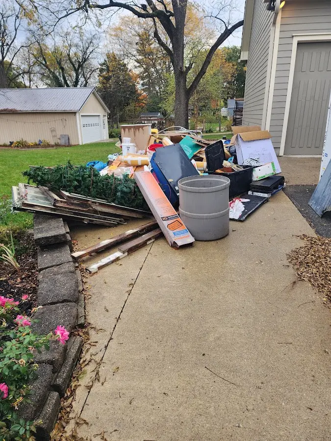Dumpster being loaded with debris for Estate Cleanout Dumpster Rental in West Des Moines